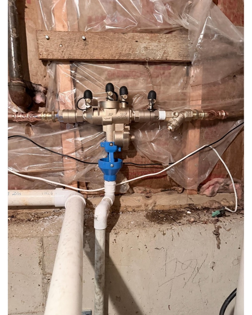 Reduced-pressure backflow assembly installed on copper in a basement