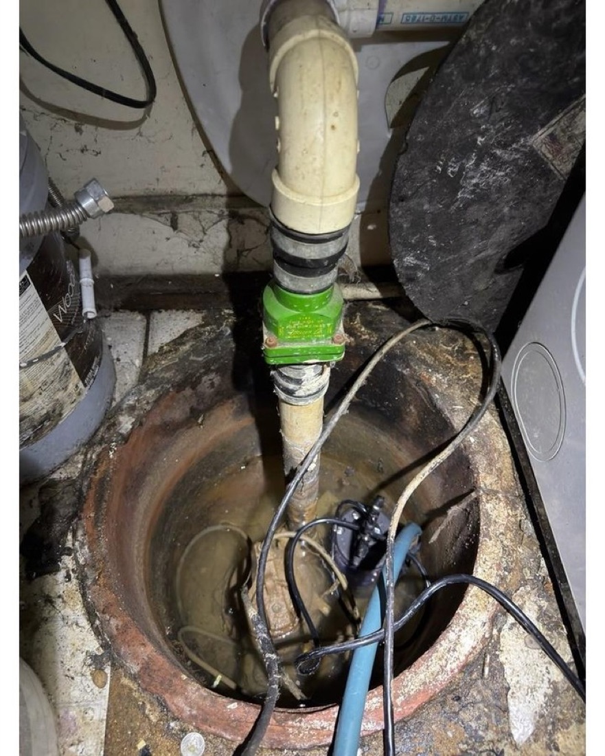 Open pump pit showing the pump, check valve and discharge piping